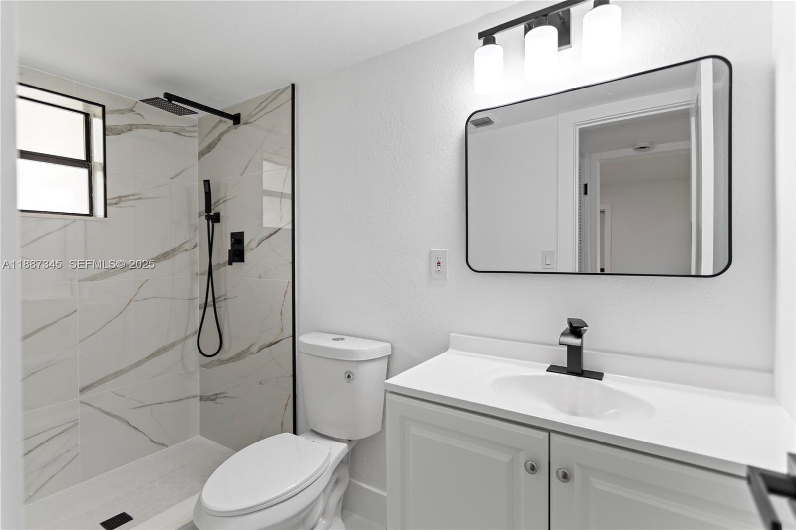 11301 Southwest 177th Street Miami, FL 33157 - Photo 24 of 31 a bathroom with a toilet sink vanity and mirror