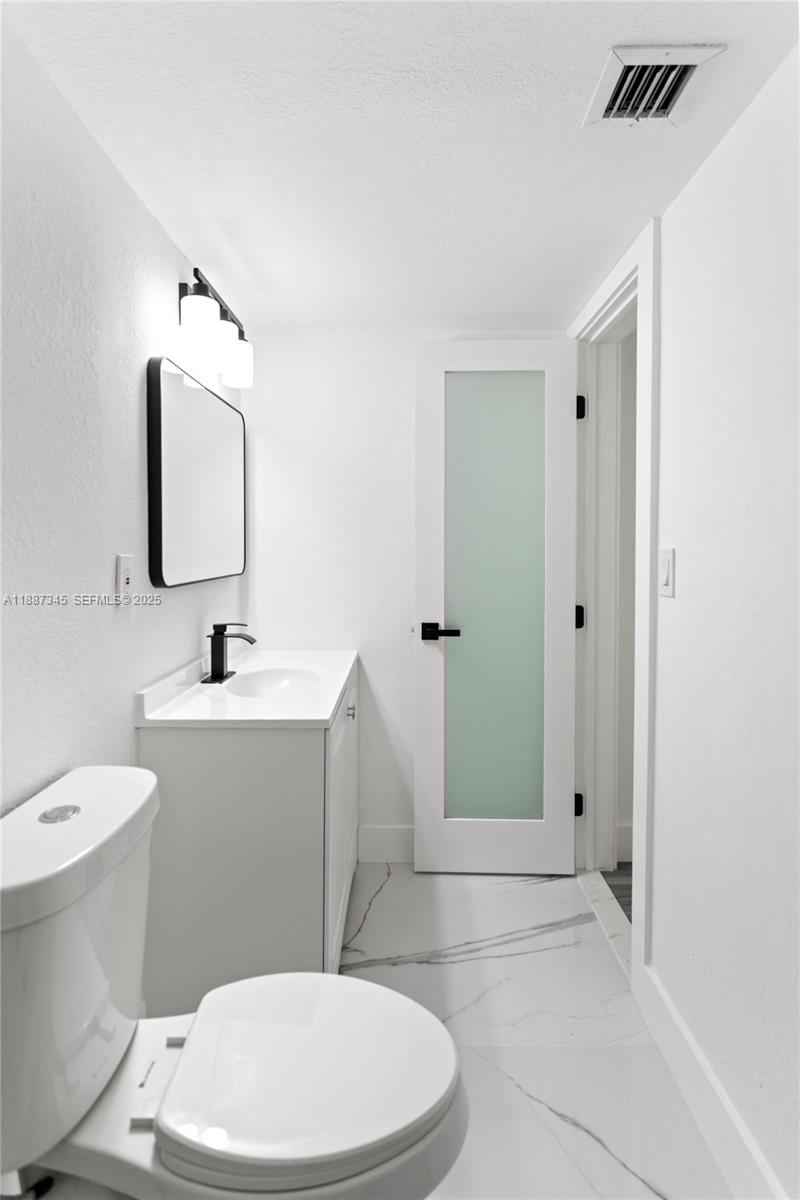 11301 Southwest 177th Street Miami, FL 33157 - Photo 25 of 31 a bathroom with a sink a toilet and shower