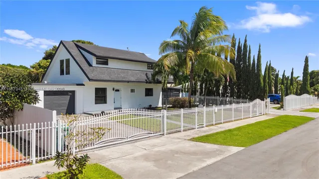 a view of a house with a swimming pool and a chairs