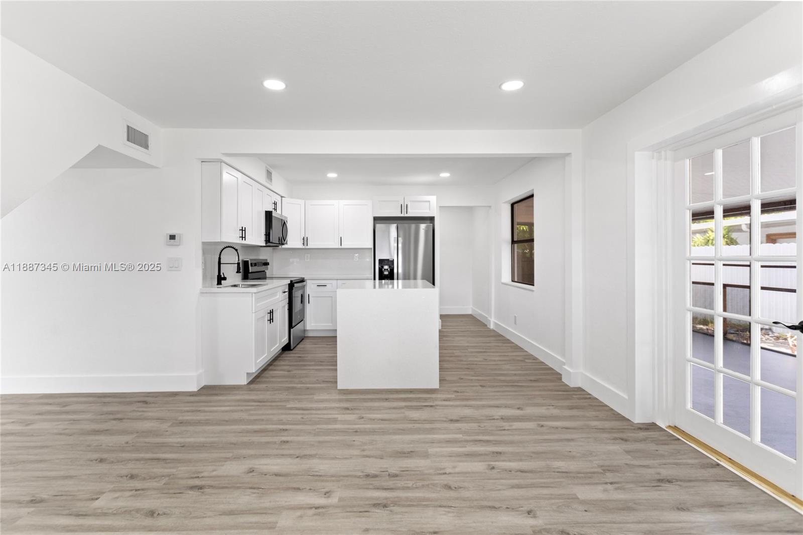 11301 Southwest 177th Street Miami, FL 33157 - Photo 10 of 31 a view of kitchen with wooden floor and electronic appliances