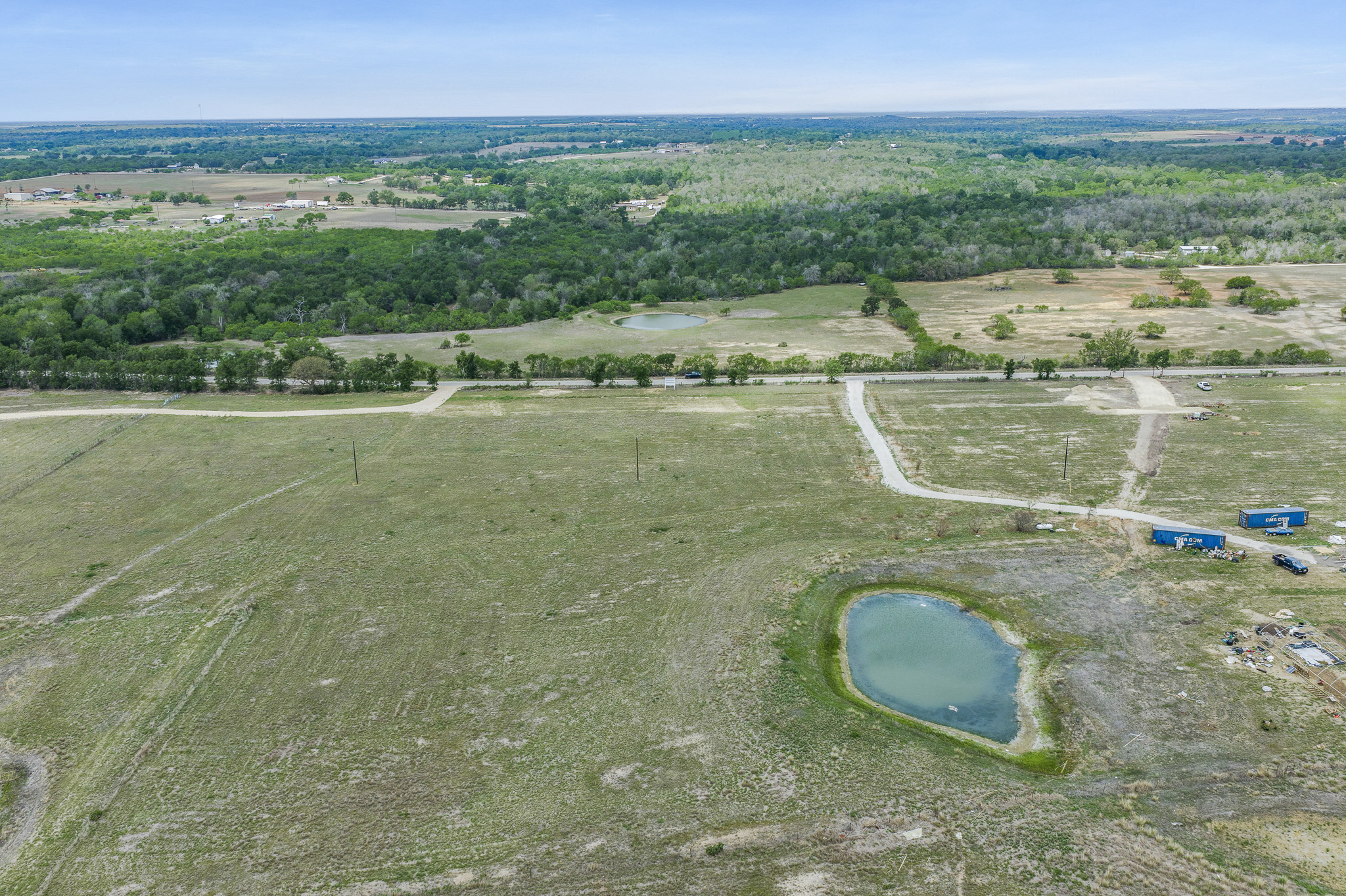 Lot 16 Mineral Springs Road Lockhart, TX 78644 - Photo 7 of 7 Expansive acreage featuring a private pond, tree line, and multiple access roads