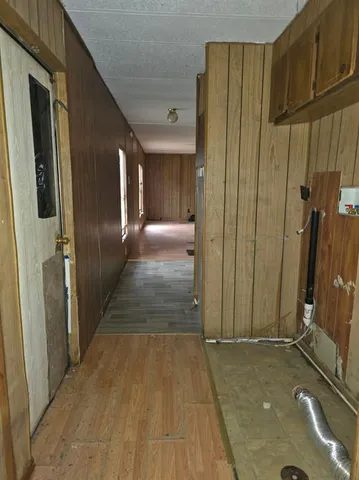 a view of a hallway with wooden walls