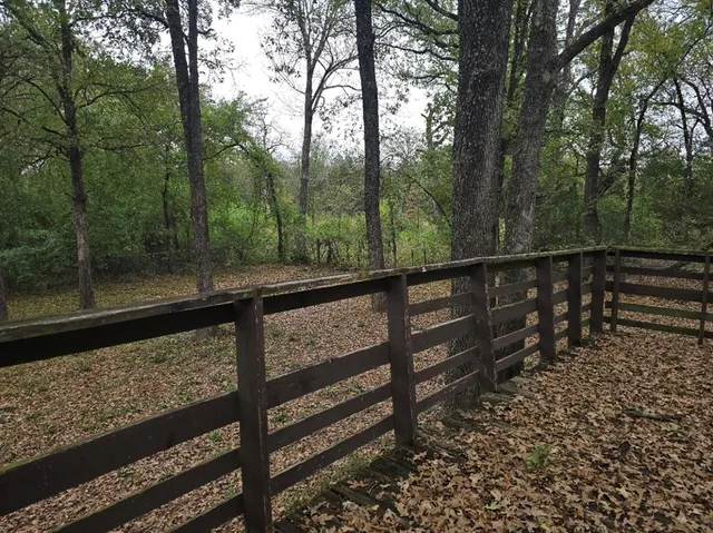 a view of a wooden deck with trees in the background