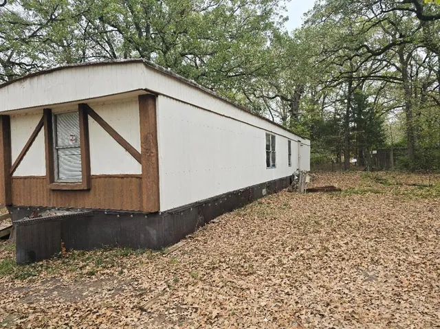 a backyard of a house with large trees