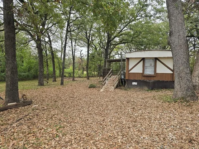 a view of outdoor space with deck and tree
