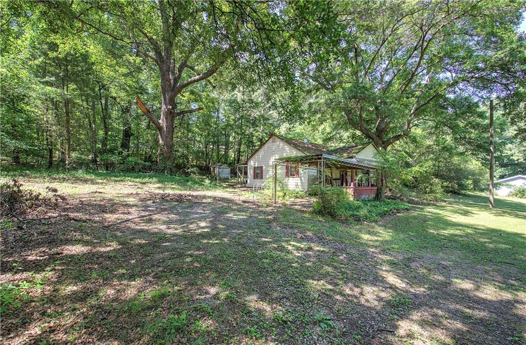 1217 Mission Road Southwest Cartersville, GA 30120 - Photo 2 of 18 a front view of a house with yard and green space