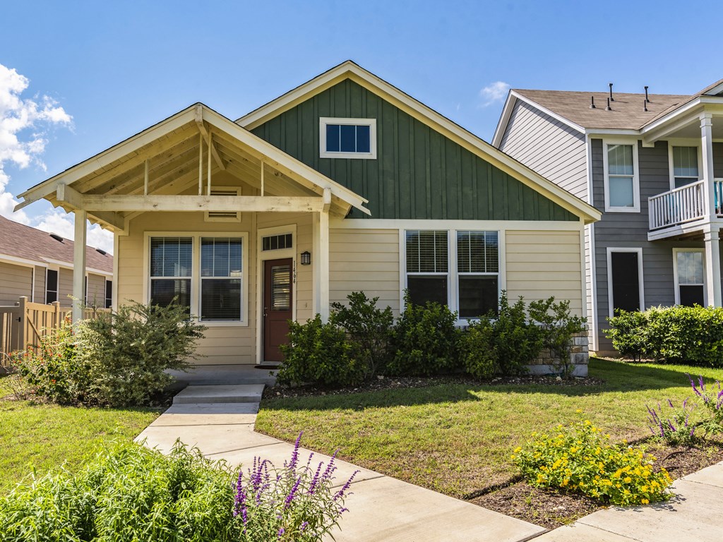 a front view of a house with garden