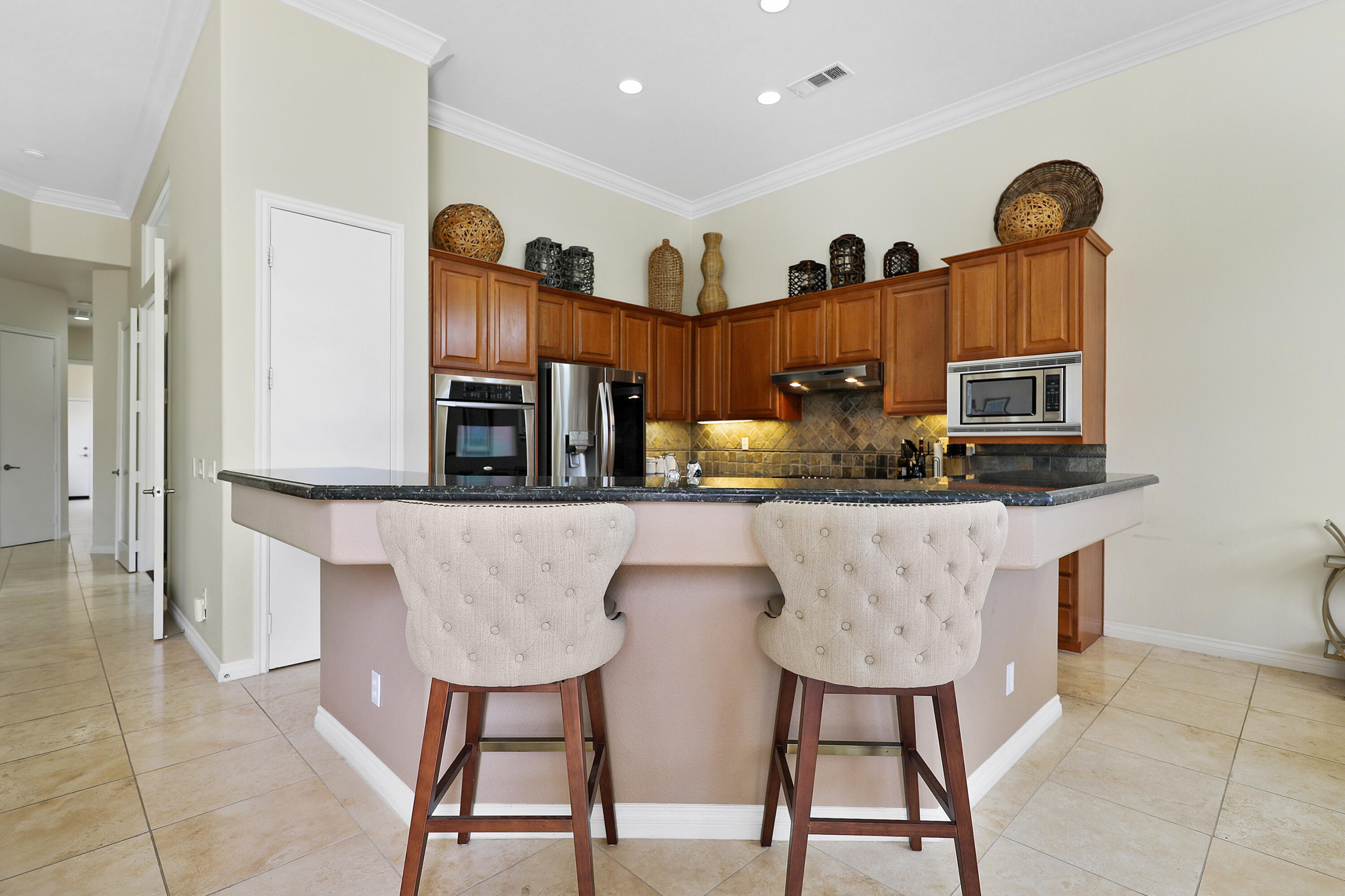 54048 Riviera La Quinta, CA 92253 - Photo 11 of 39 a living room with stainless steel appliances furniture a rug and a view of kitchen