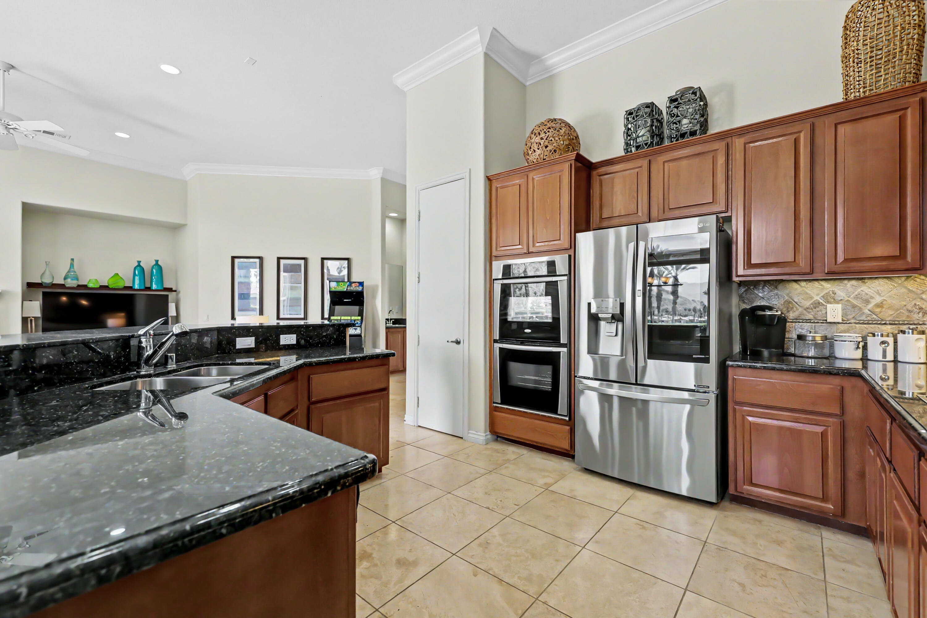 54048 Riviera La Quinta, CA 92253 - Photo 13 of 39 a kitchen with stainless steel appliances granite countertop a refrigerator a stove and a sink