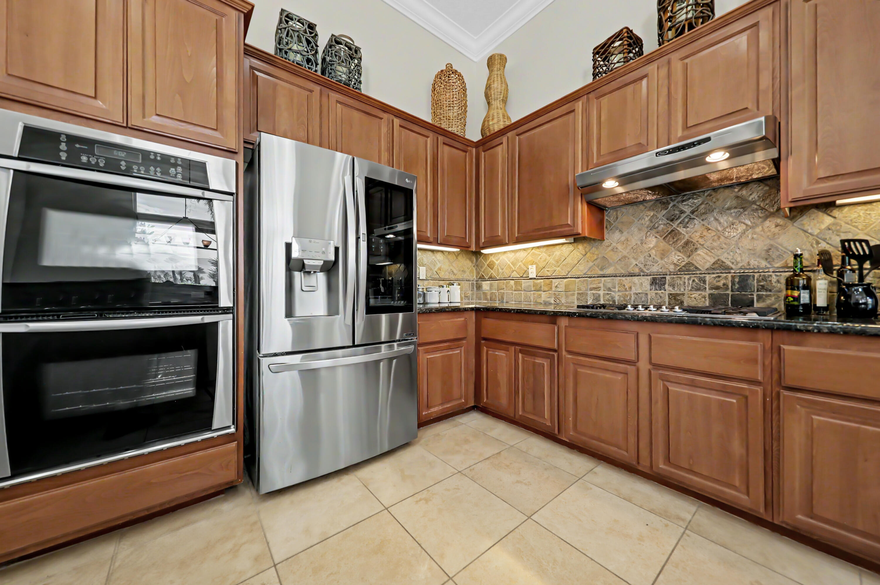 54048 Riviera La Quinta, CA 92253 - Photo 14 of 39 a kitchen with granite countertop stainless steel appliances and white cabinets