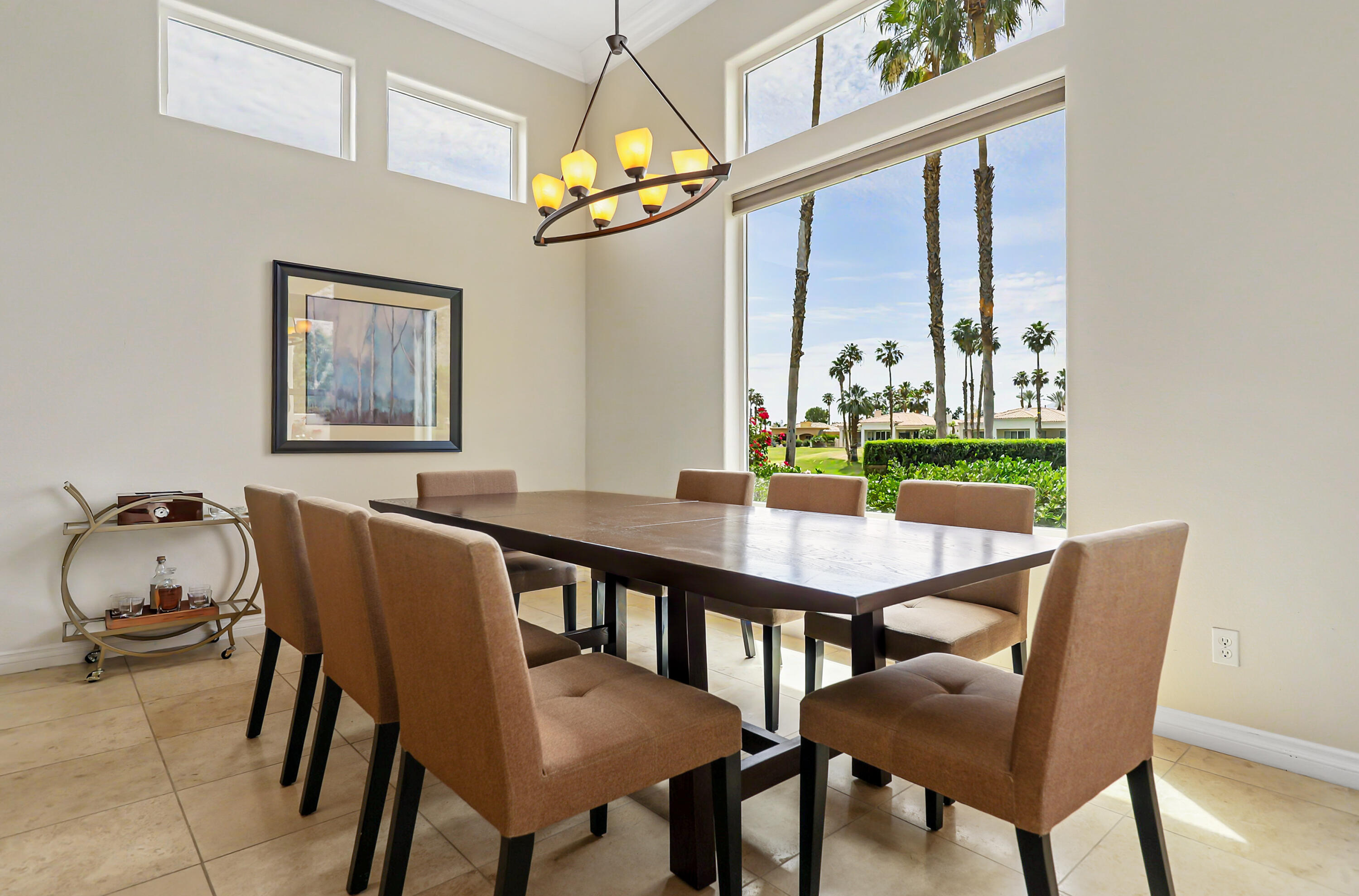 54048 Riviera La Quinta, CA 92253 - Photo 15 of 39 a view of a dining room with furniture a chandelier and large windows