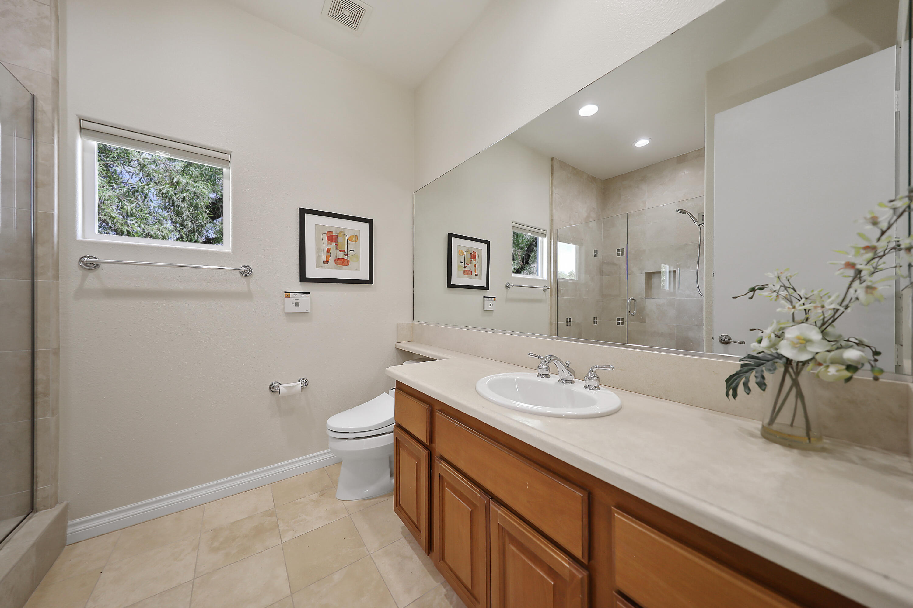 54048 Riviera La Quinta, CA 92253 - Photo 28 of 39 a bathroom with a granite countertop sink a toilet and a mirror