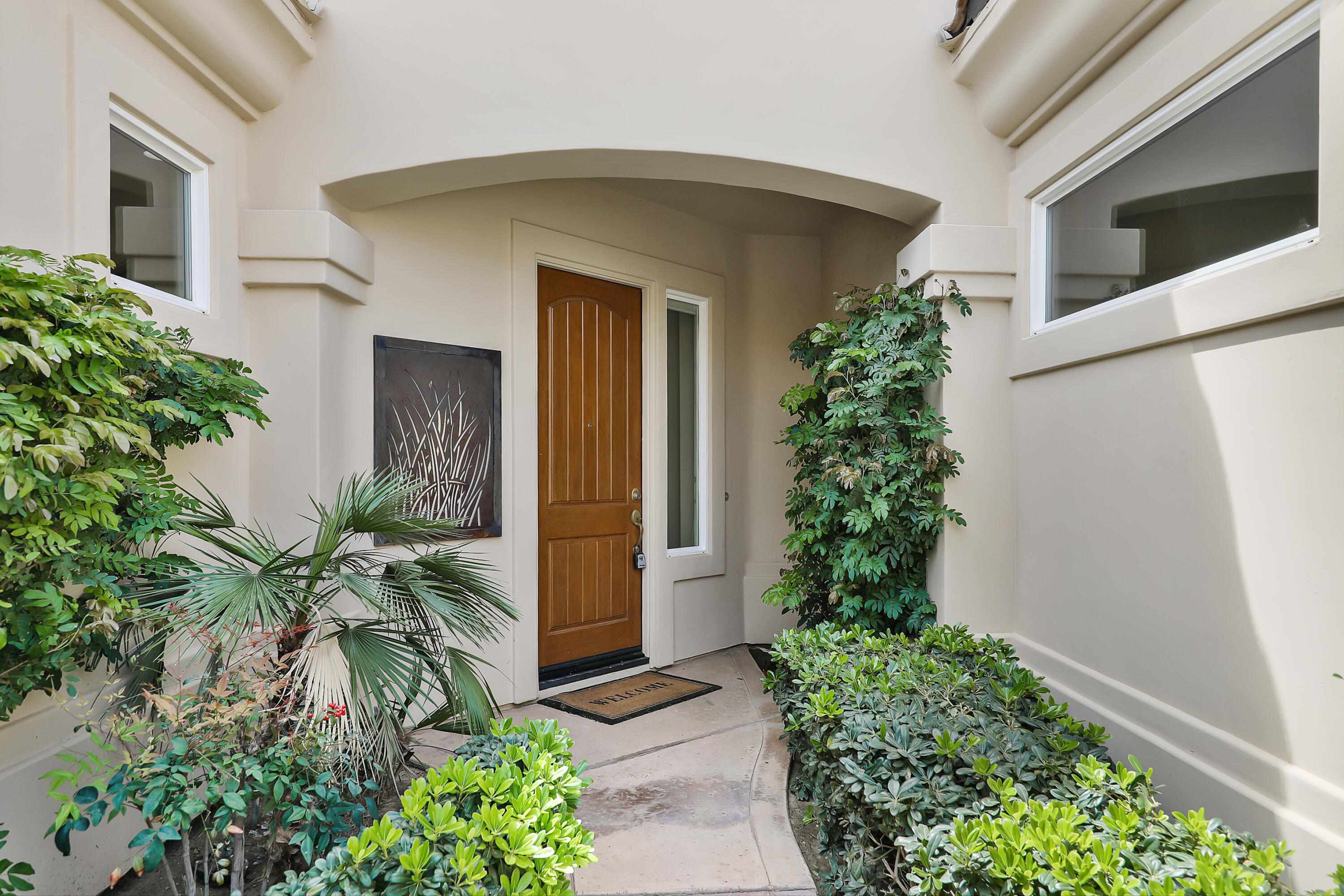 54048 Riviera La Quinta, CA 92253 - Photo 5 of 39 a front view of a house with a yard