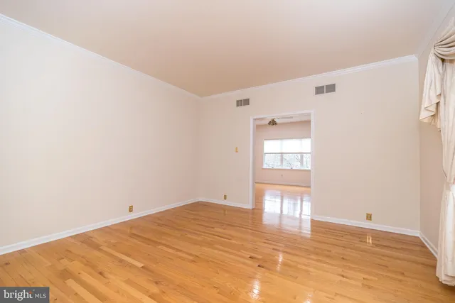 a view of a big room with wooden floor and a bathroom