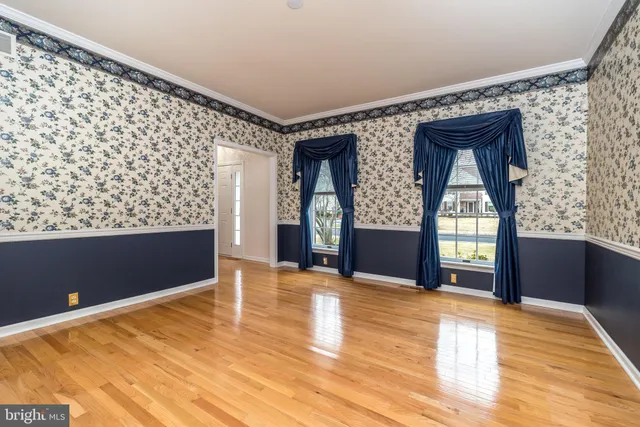 a view of an empty room with a window and fireplace
