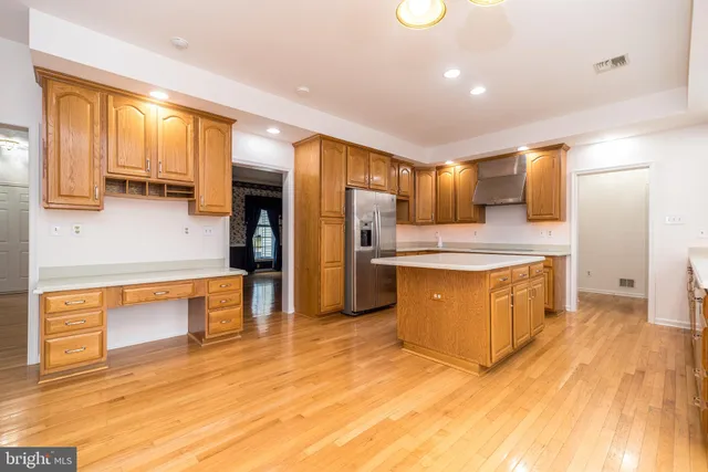a kitchen with stainless steel appliances granite countertop a sink and refrigerator