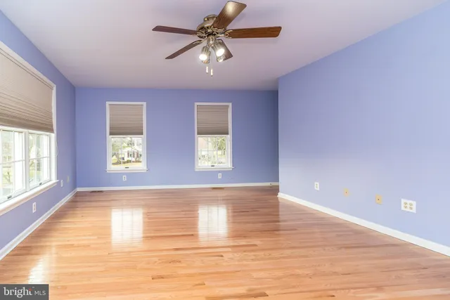 a spacious bathroom with a granite countertop sink a toilet and a mirror