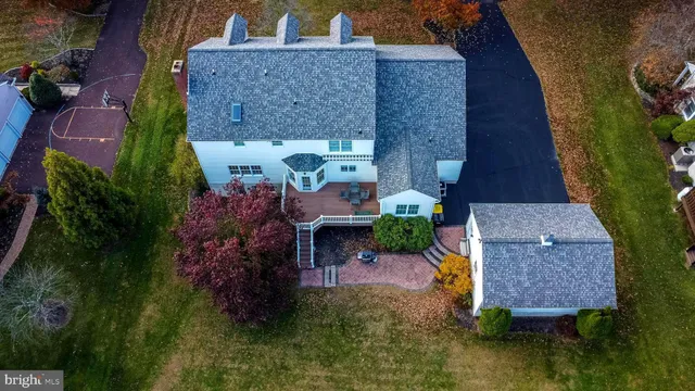 an aerial view of a house with garden space and street view