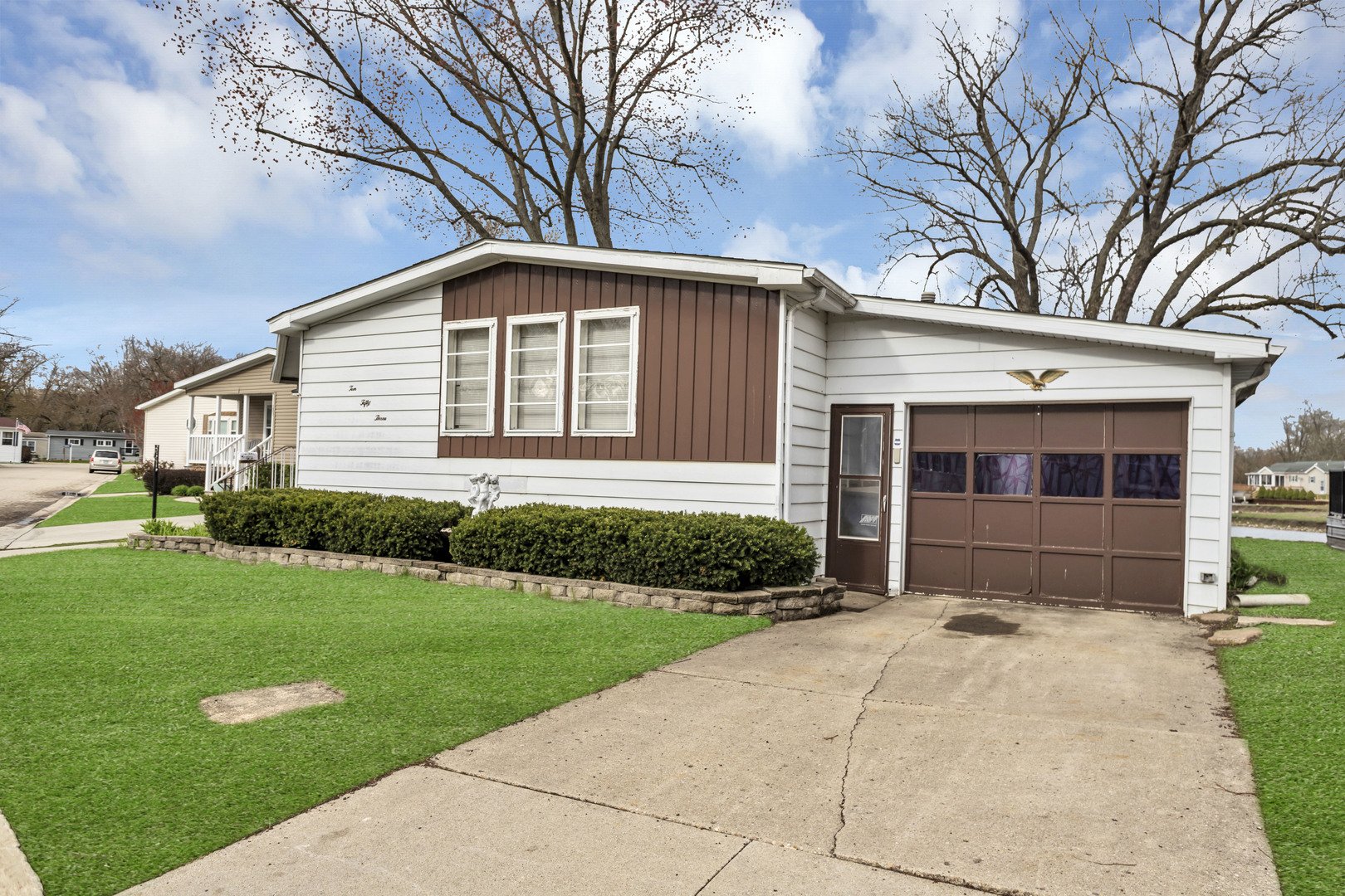 1053 Lakeview Road Elgin, IL 60123 - Photo 1 of 33 a front view of a house with a yard and garage