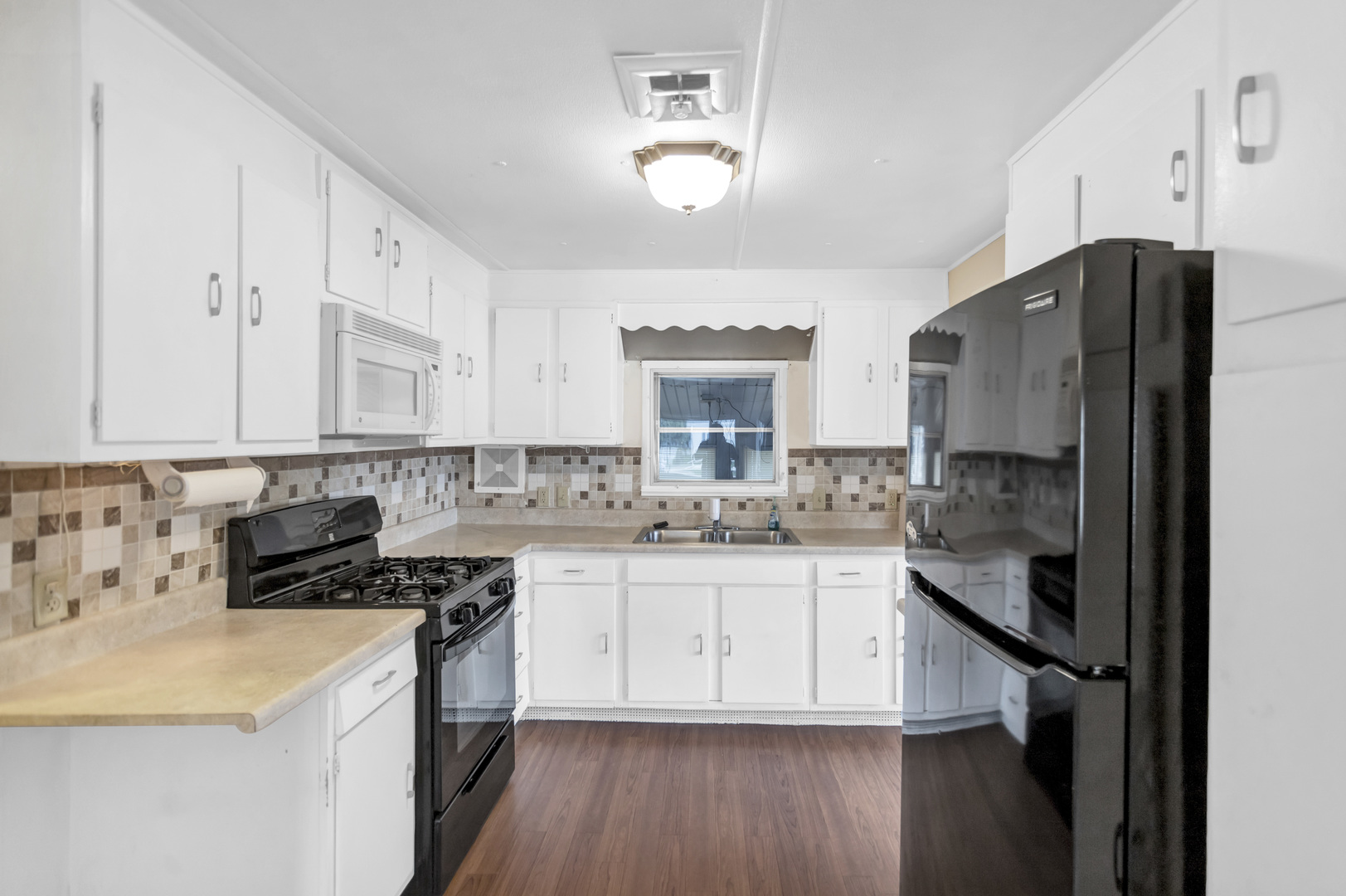 1053 Lakeview Road Elgin, IL 60123 - Photo 11 of 33 a kitchen with a sink a refrigerator and cabinets