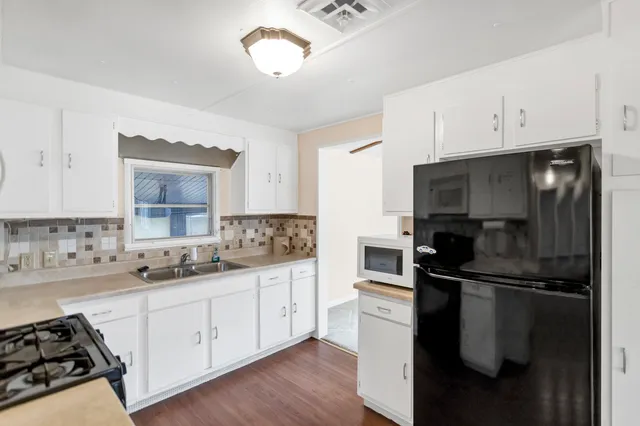 a kitchen with a sink appliances and cabinets