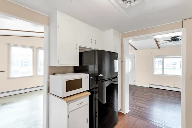 a kitchen with stainless steel appliances a stove microwave and sink