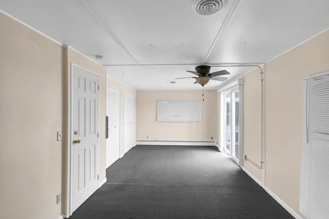 a view of a livingroom with a ceiling fan and window