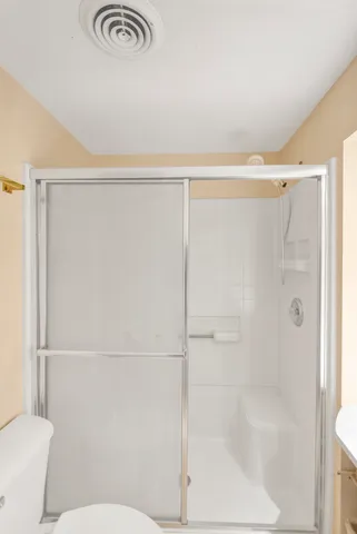 a bathroom with a shower and a toilet