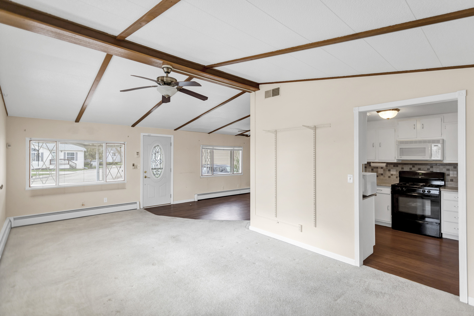 1053 Lakeview Road Elgin, IL 60123 - Photo 6 of 33 a view of a livingroom with an empty space and a window