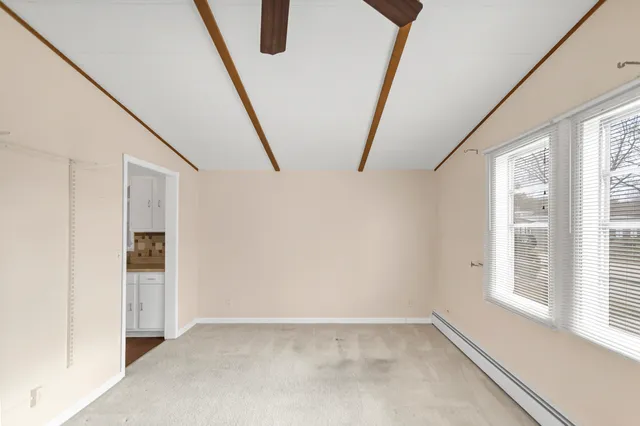 a view of an empty room with windows