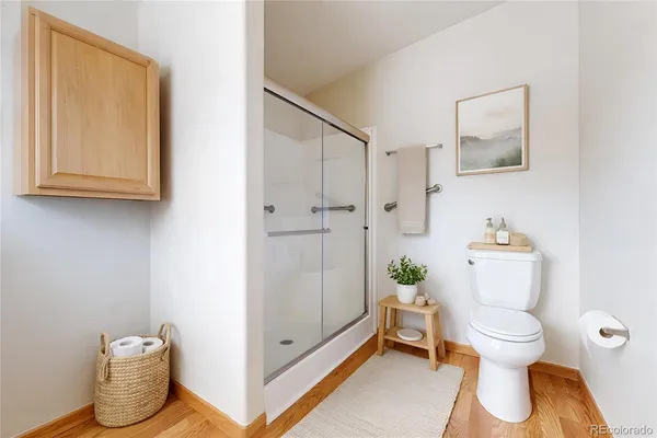 a bathroom with a toilet and a shower