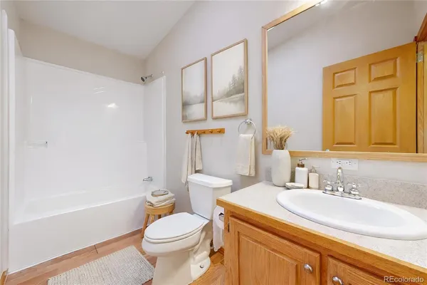 a bathroom with a granite countertop toilet sink and a bathtub