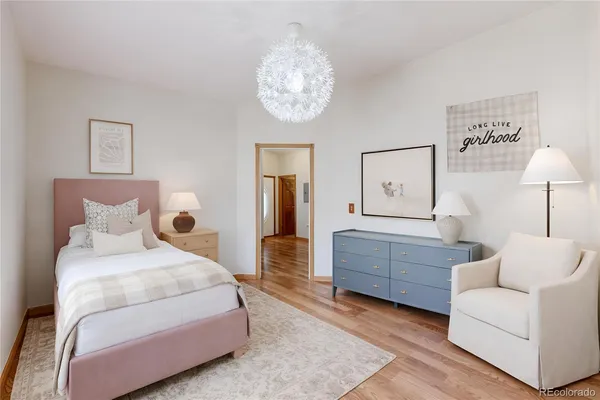 a bedroom with a bed and a chandelier