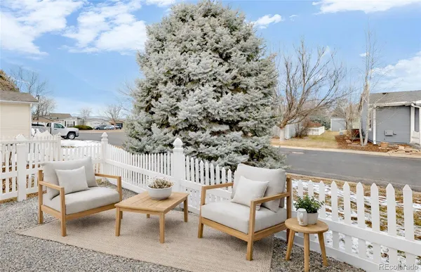 a view of a patio with couches and table and chairs and potted plants