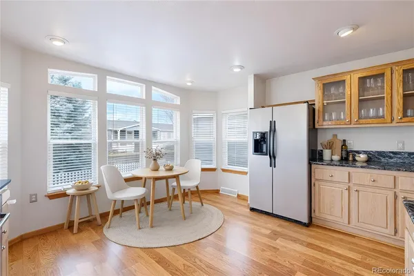 a dining room with furniture a chandelier and wooden floor
