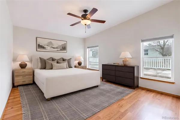 a bedroom with a bed and a painting on the wall