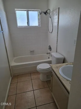 a bathroom with a toilet a sink and a shower
