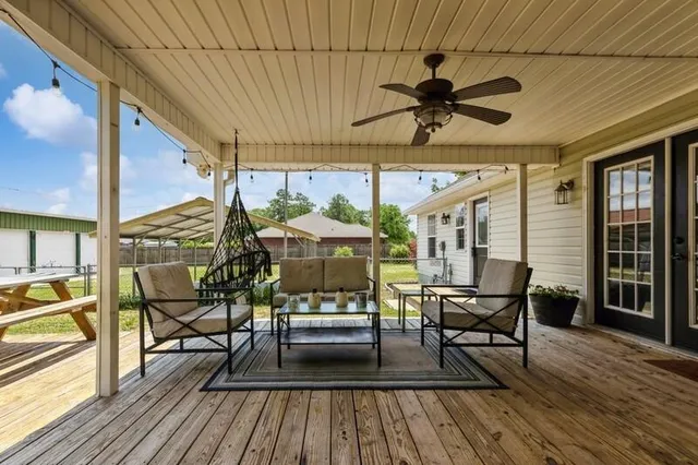 a view of a patio with table and chairs