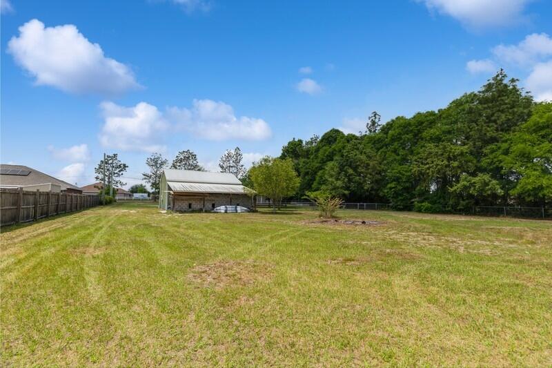 2377 Lake Silver Road Crestview, FL 32536 - Photo 16 of 36 a swimming pool with trees in the background