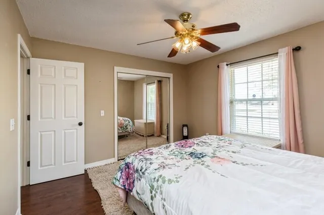 a bedroom with a large bed and a window