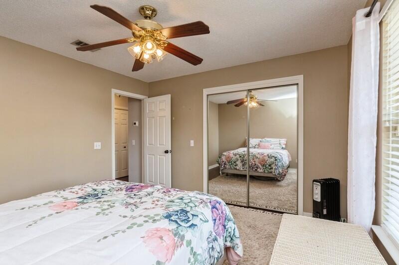 2377 Lake Silver Road Crestview, FL 32536 - Photo 29 of 36 a bedroom with a bed and a chandelier