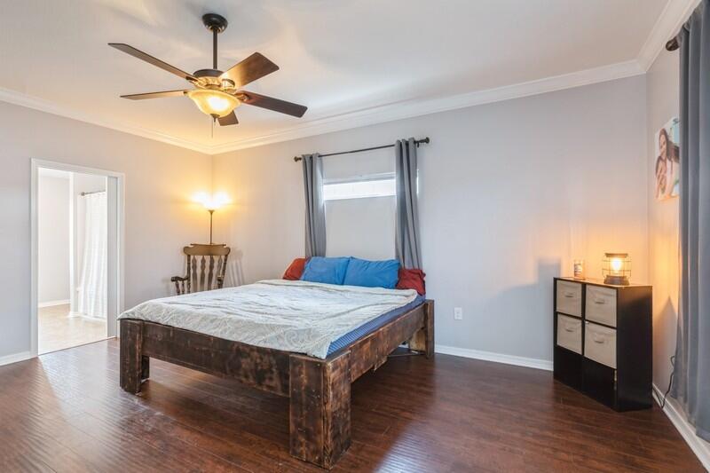 2377 Lake Silver Road Crestview, FL 32536 - Photo 35 of 36 a room with wooden floor and ceiling fan