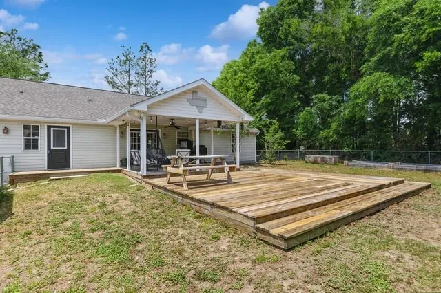 a view of a house with pool and chairs