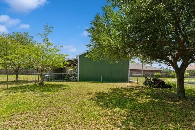 a backyard of a house with lots of green space