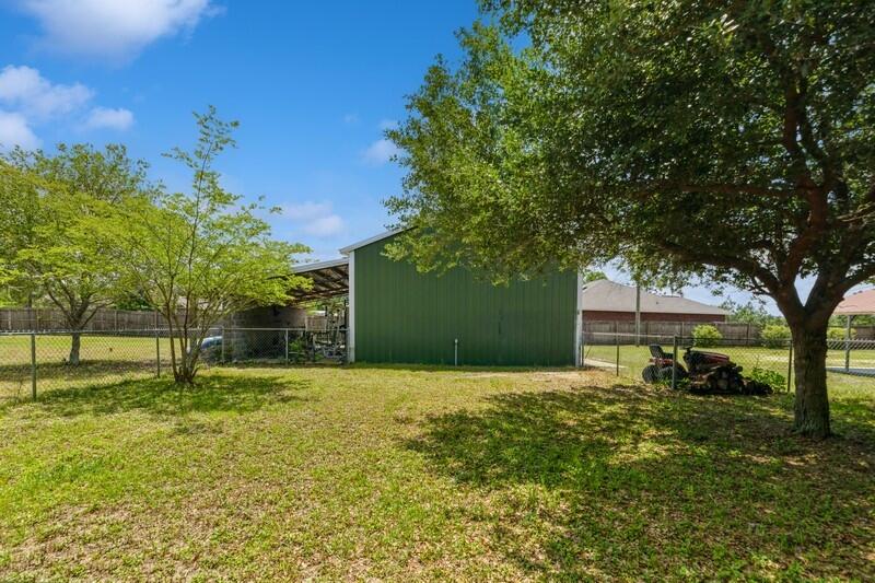 2377 Lake Silver Road Crestview, FL 32536 - Photo 9 of 36 a backyard of a house with lots of green space