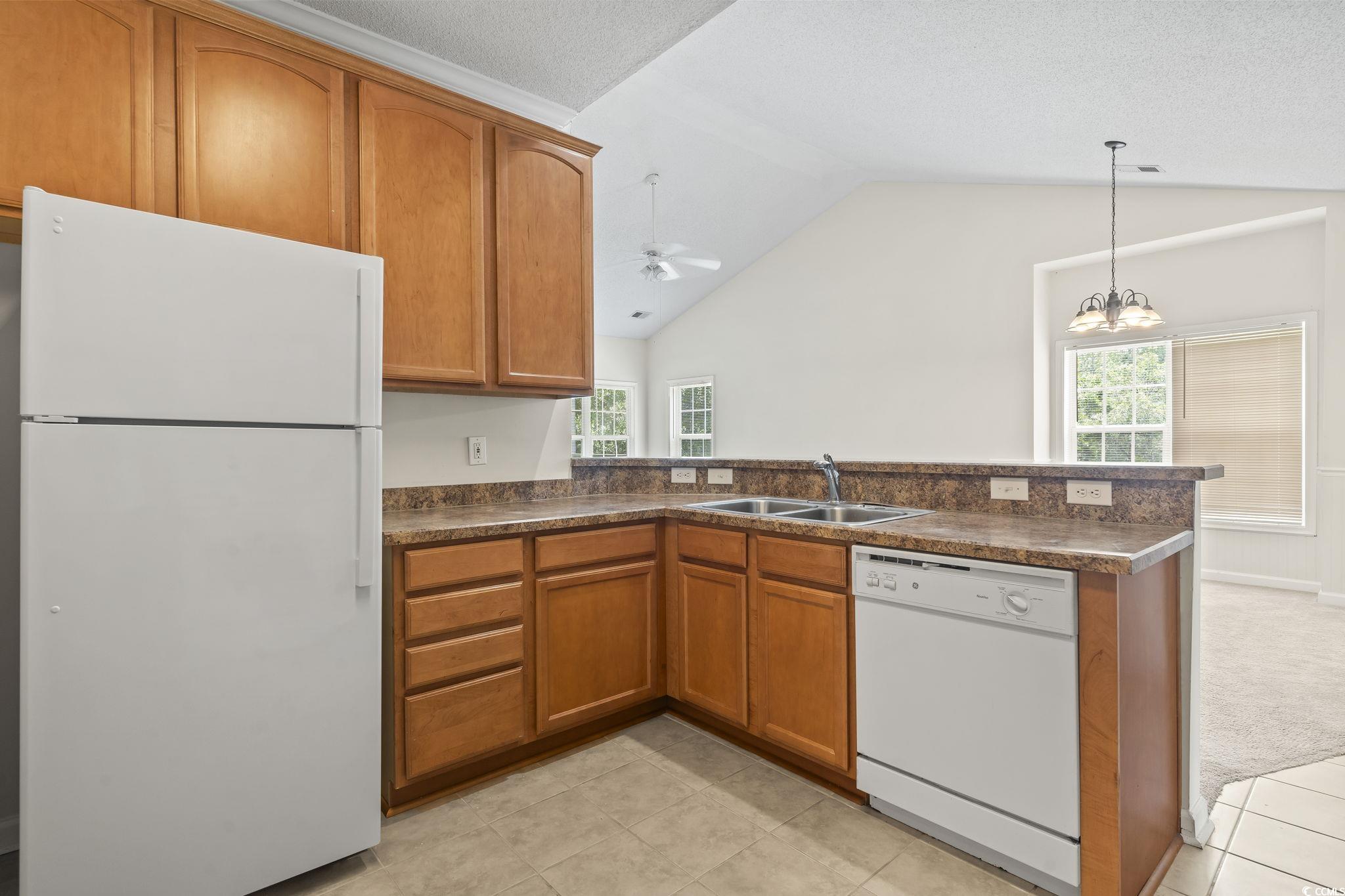 5810 Longwood Drive, Unit 14304 Murrells Inlet, SC 29576 - Photo 14 of 30 Kitchen featuring white appliances, brown cabinets