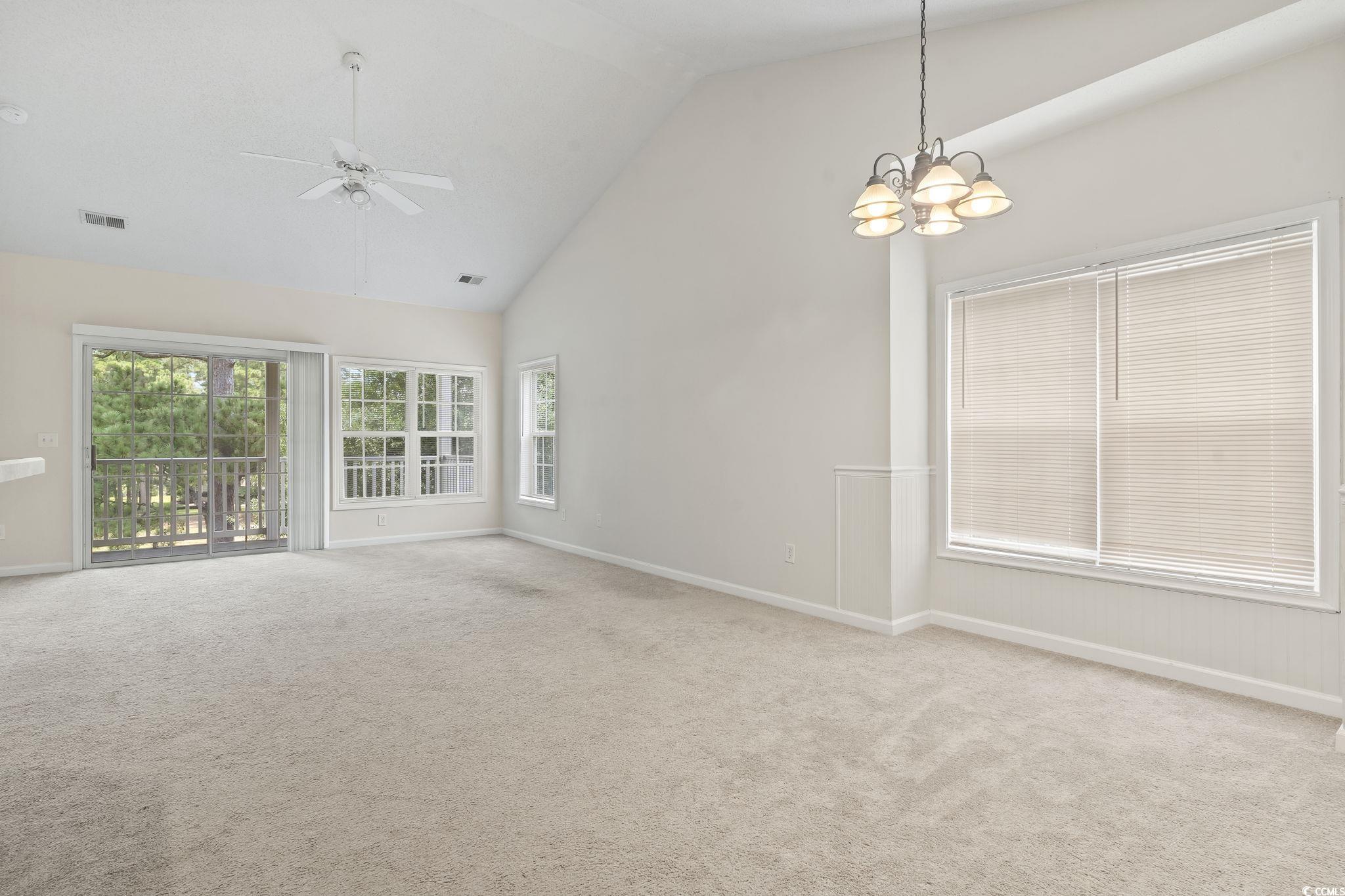 5810 Longwood Drive, Unit 14304 Murrells Inlet, SC 29576 - Photo 16 of 30 Empty room with high vaulted ceiling, a chandelier