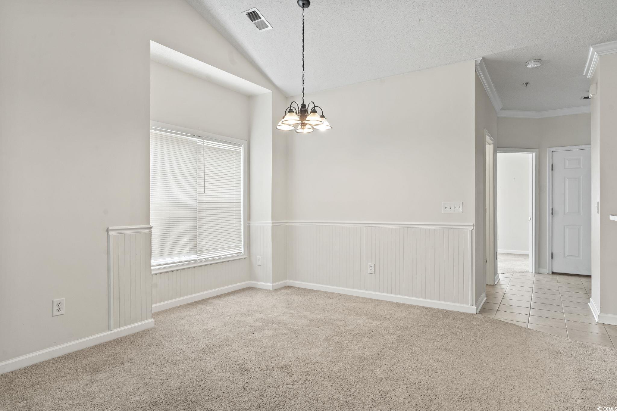 5810 Longwood Drive, Unit 14304 Murrells Inlet, SC 29576 - Photo 19 of 30 Carpeted empty room with a chandelier, tile patter