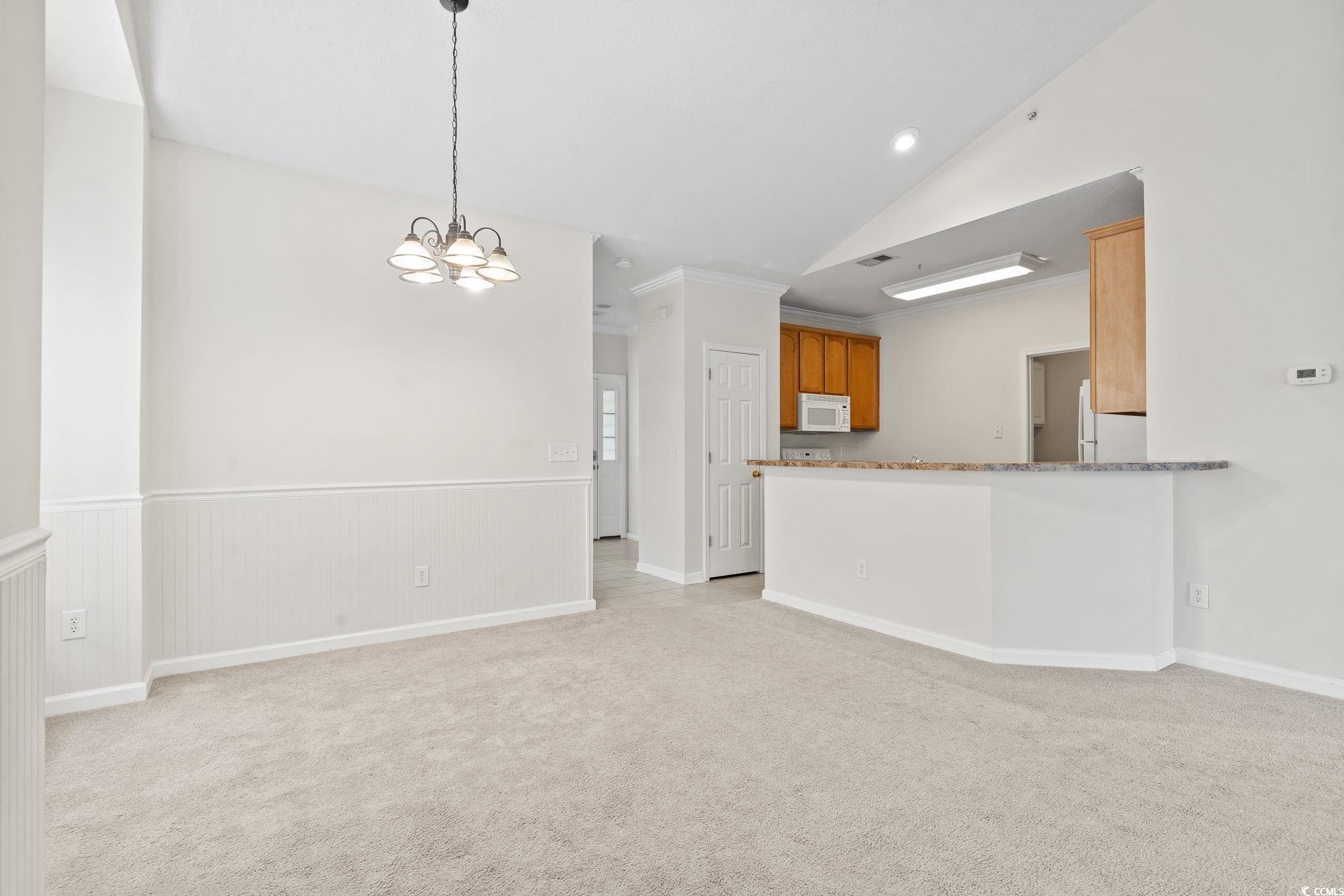 5810 Longwood Drive, Unit 14304 Murrells Inlet, SC 29576 - Photo 20 of 30 Kitchen featuring white appliances, a chandelier,