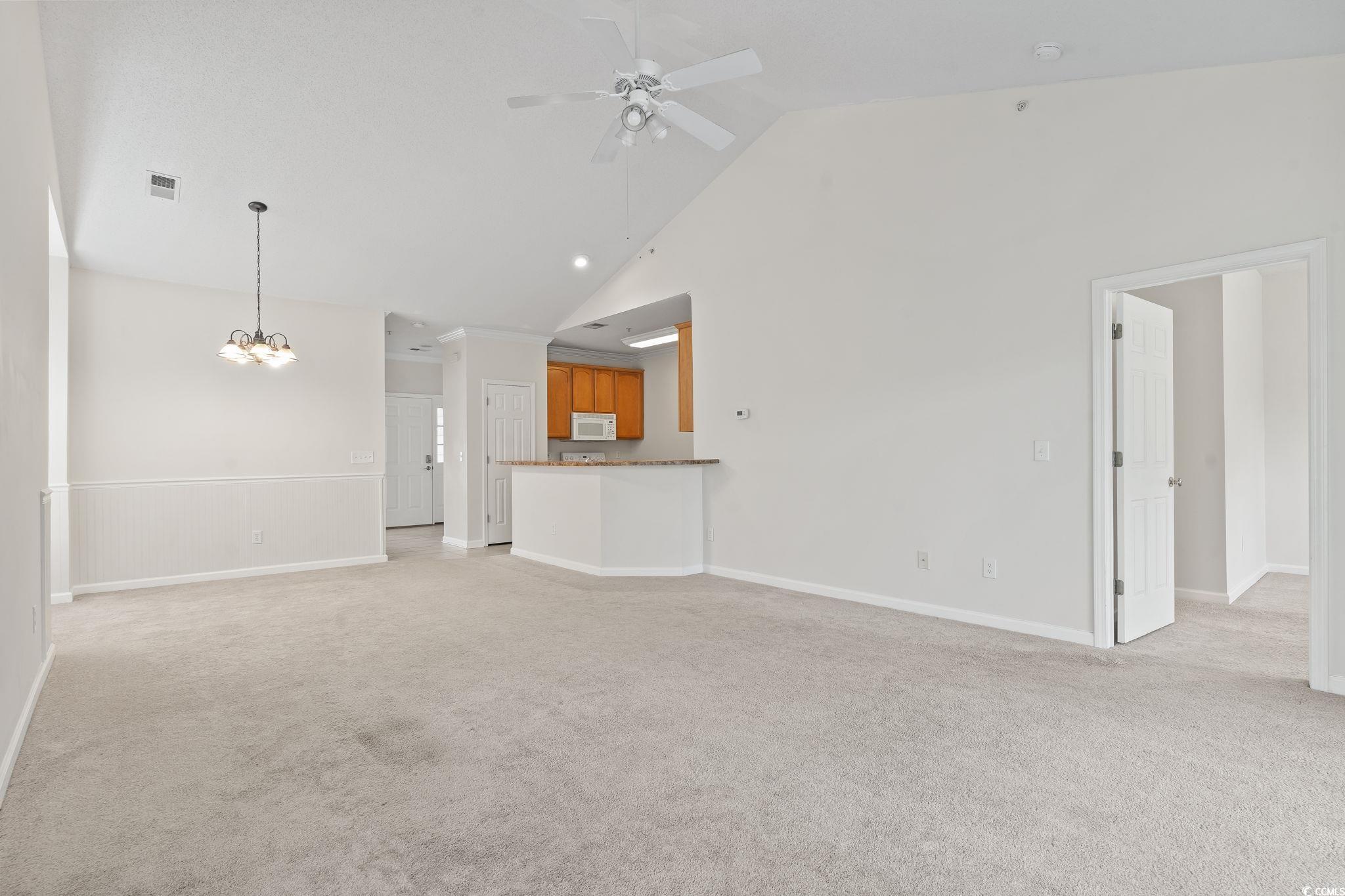 5810 Longwood Drive, Unit 14304 Murrells Inlet, SC 29576 - Photo 22 of 30 Unfurnished living room with light carpet, high va